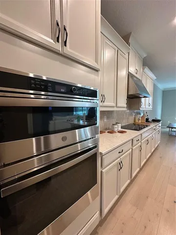 a view of a dining room with furniture and a window