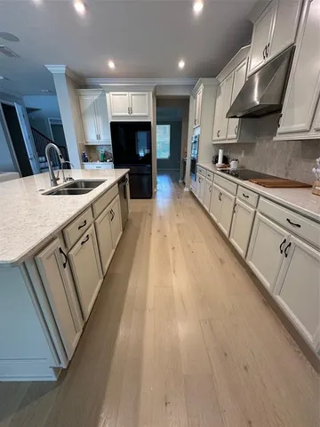 a kitchen with a stove and a refrigerator