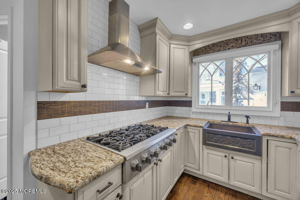 412 Brighton Avenue Spring Lake, NJ 07762 - Photo 14 of 56 a kitchen with stainless steel appliances granite countertop a sink stove and cabinets