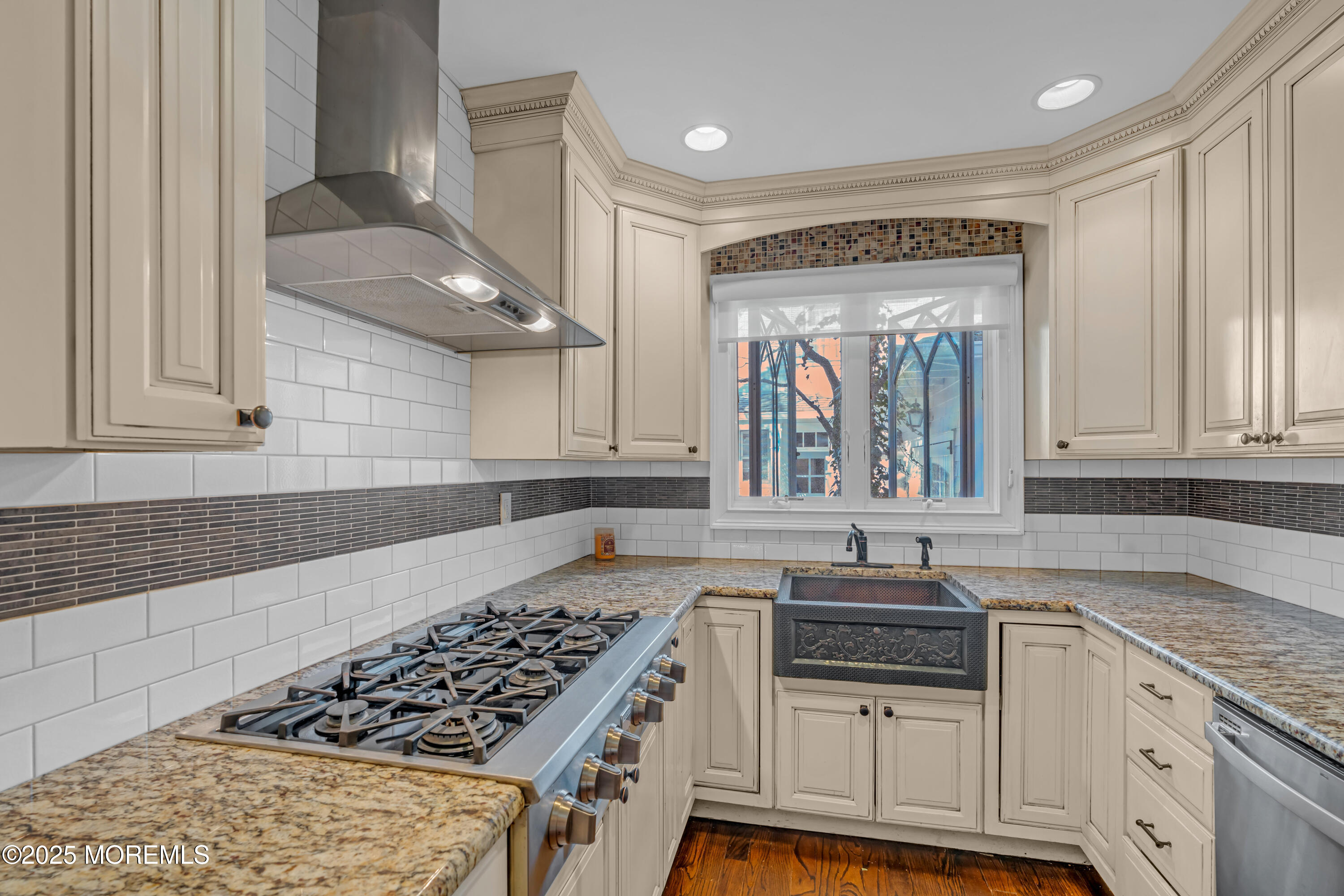 412 Brighton Avenue Spring Lake, NJ 07762 - Photo 16 of 56 a kitchen with granite countertop a stove a sink and white cabinets