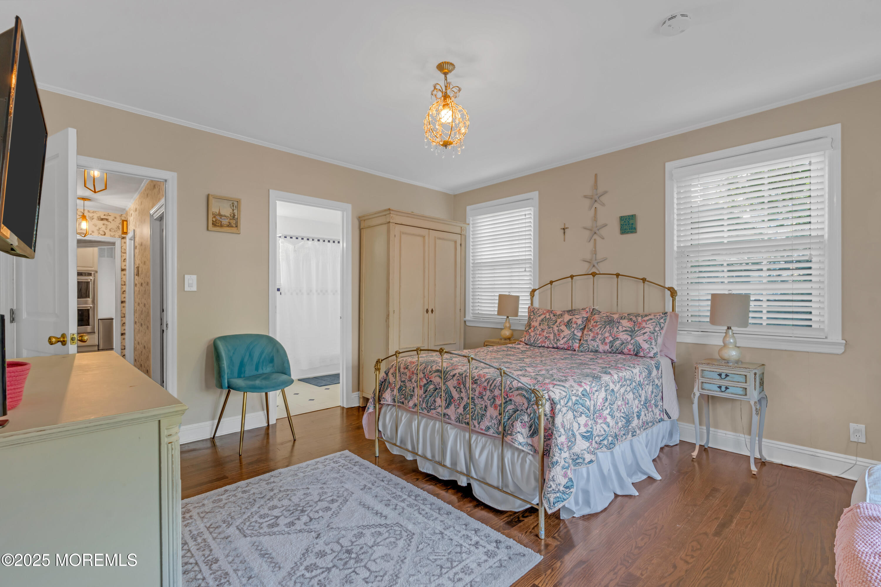 412 Brighton Avenue Spring Lake, NJ 07762 - Photo 21 of 56 a bedroom with a bed and a chandelier