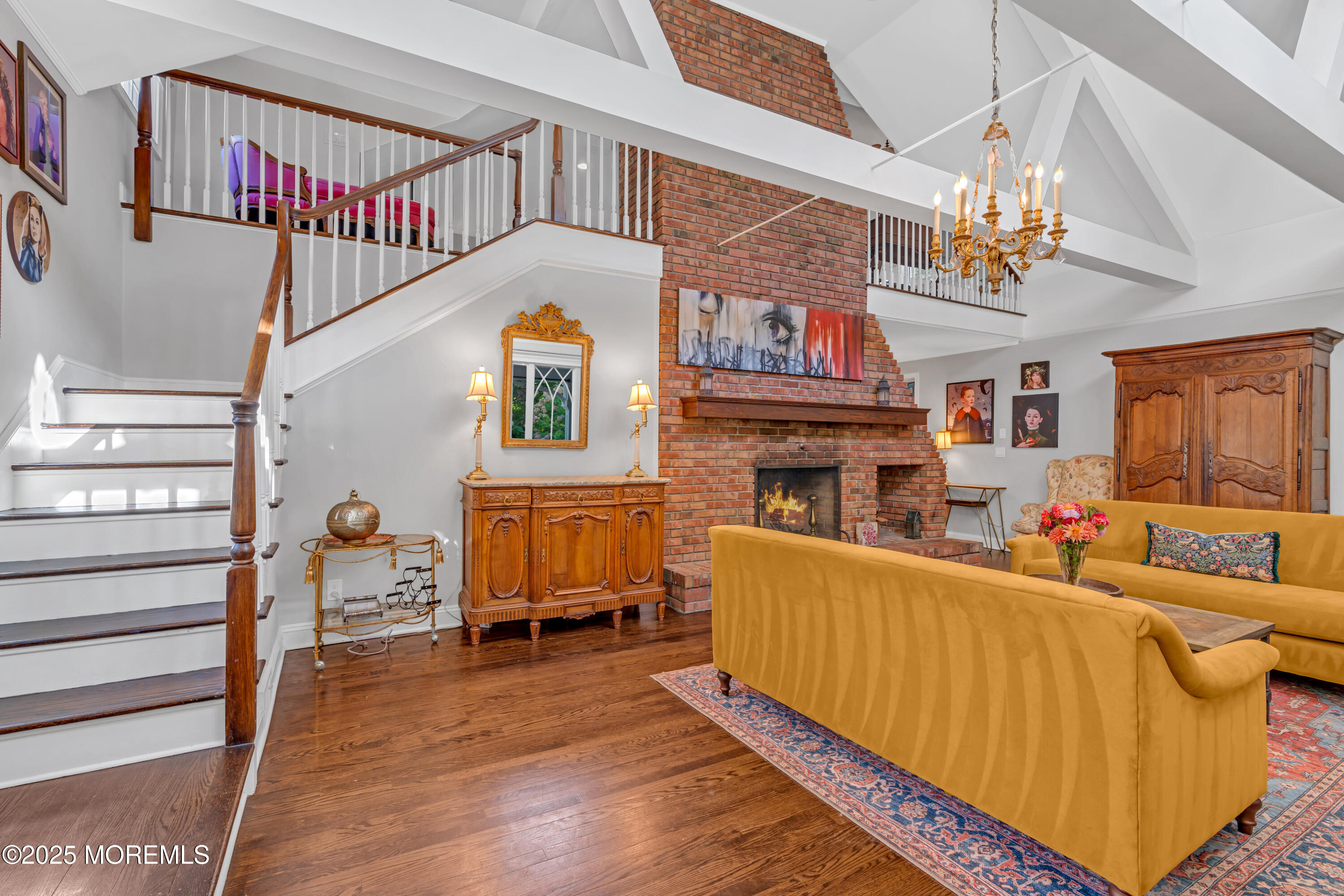 412 Brighton Avenue Spring Lake, NJ 07762 - Photo 27 of 56 a living room with furniture a fireplace and a chandelier
