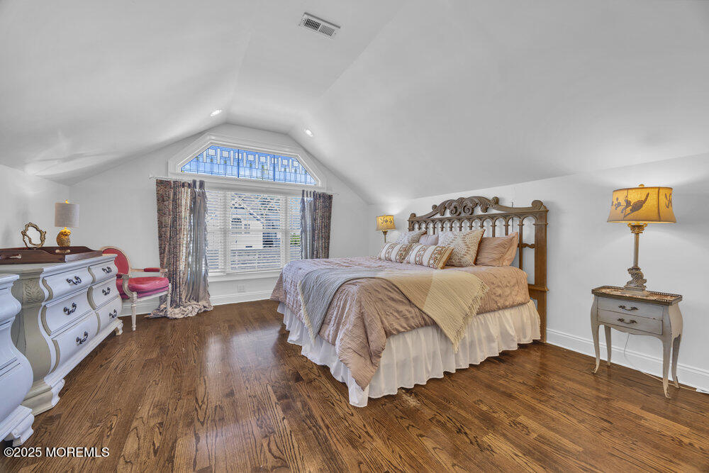 412 Brighton Avenue Spring Lake, NJ 07762 - Photo 35 of 56 a bedroom with a bed and wooden floor