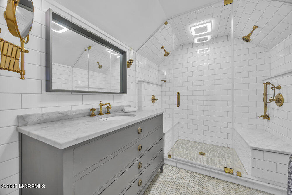 412 Brighton Avenue Spring Lake, NJ 07762 - Photo 37 of 56 a bathroom with a sink vanity granite shower and a mirror