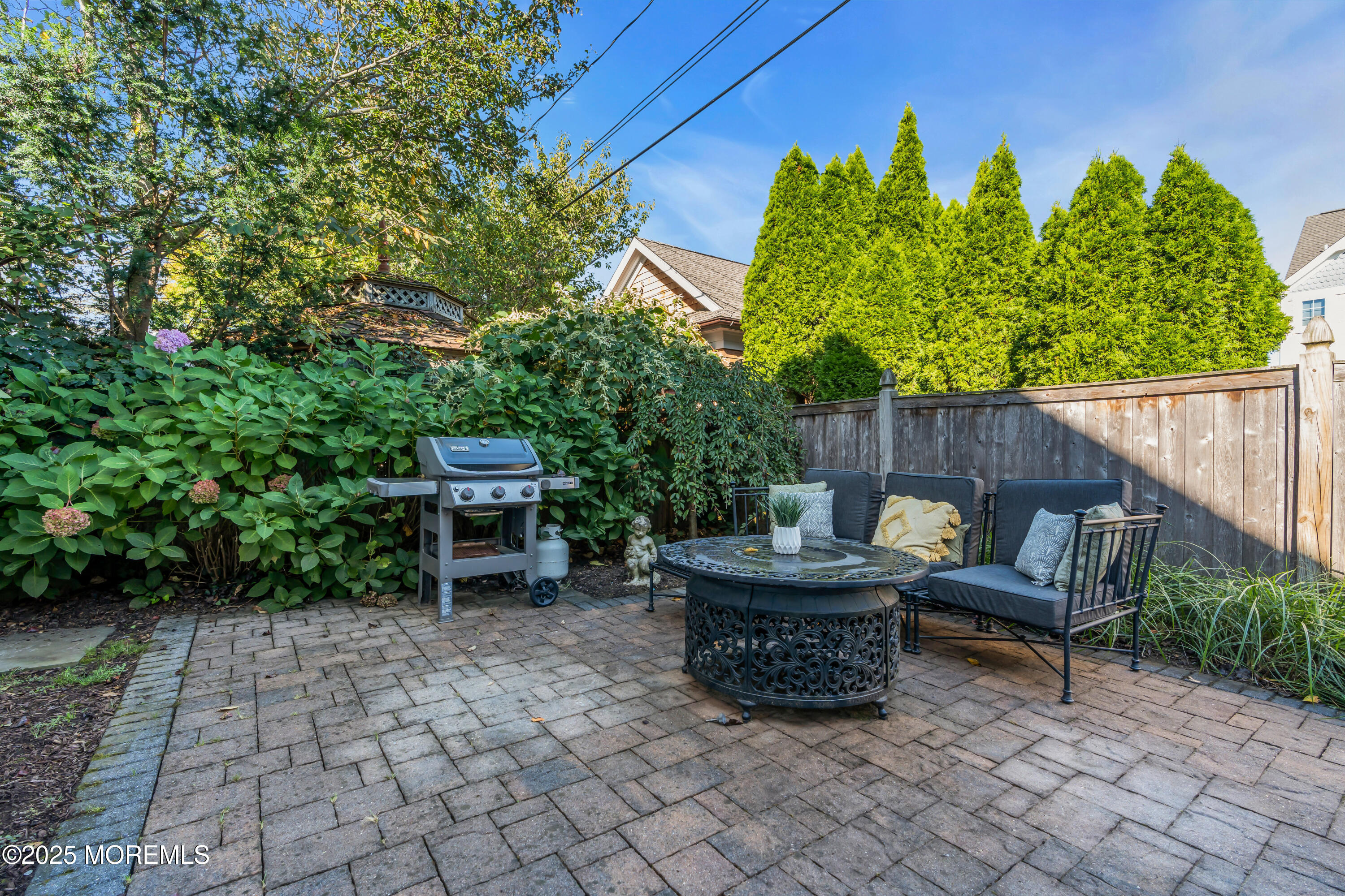 412 Brighton Avenue Spring Lake, NJ 07762 - Photo 42 of 56 a wooden bench sitting in the middle of a backyard
