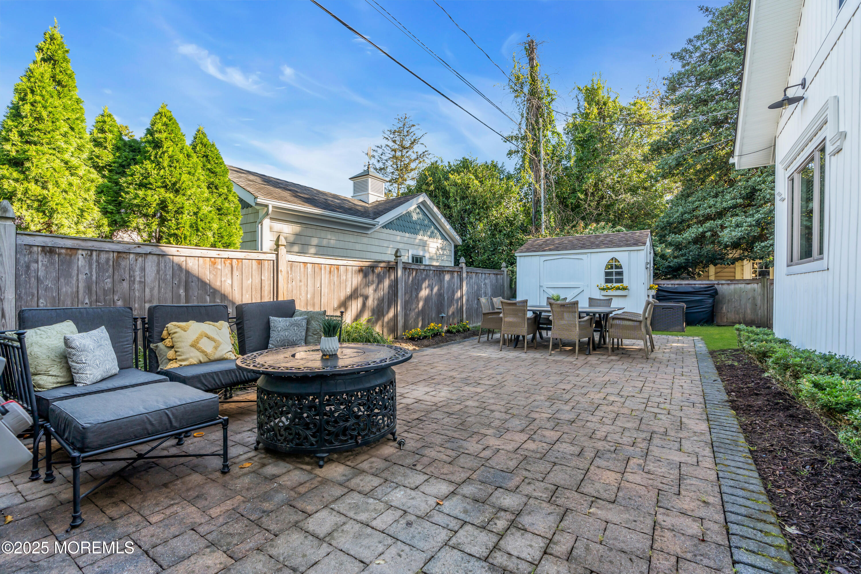 412 Brighton Avenue Spring Lake, NJ 07762 - Photo 43 of 56 a backyard of a house with barbeque oven table and chairs
