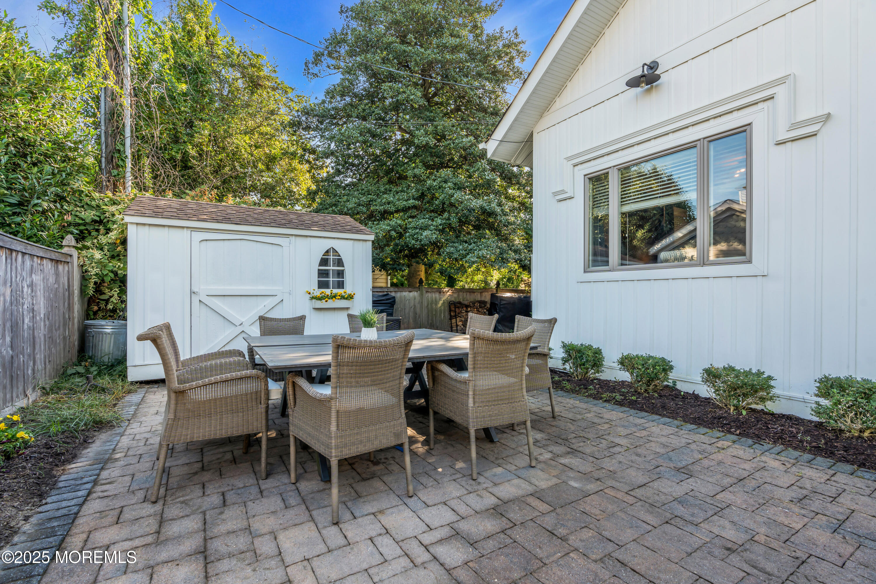 412 Brighton Avenue Spring Lake, NJ 07762 - Photo 44 of 56 a view of a patio with a dining table and chairs