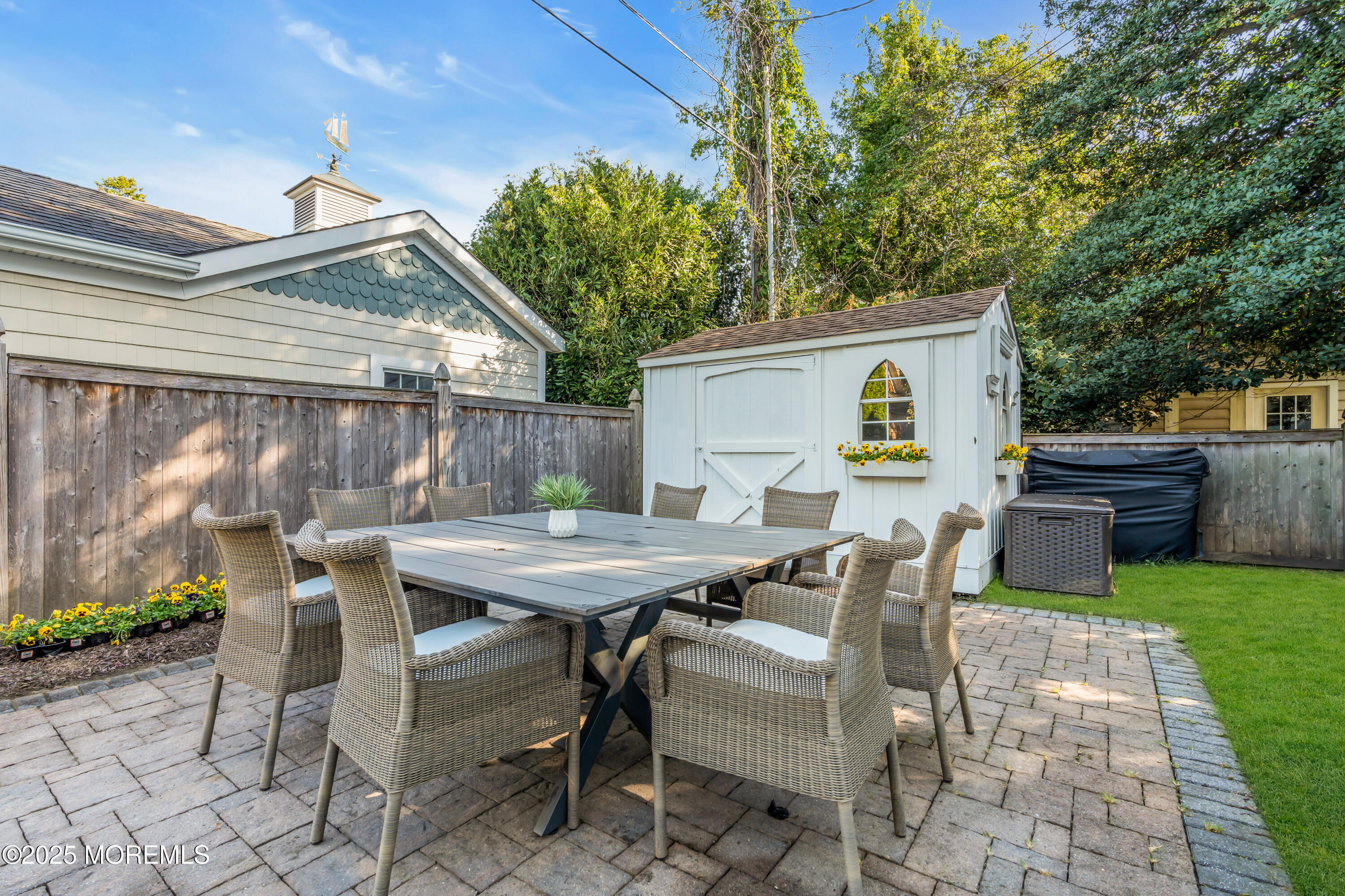 412 Brighton Avenue Spring Lake, NJ 07762 - Photo 45 of 56 a backyard of a house with table and chairs