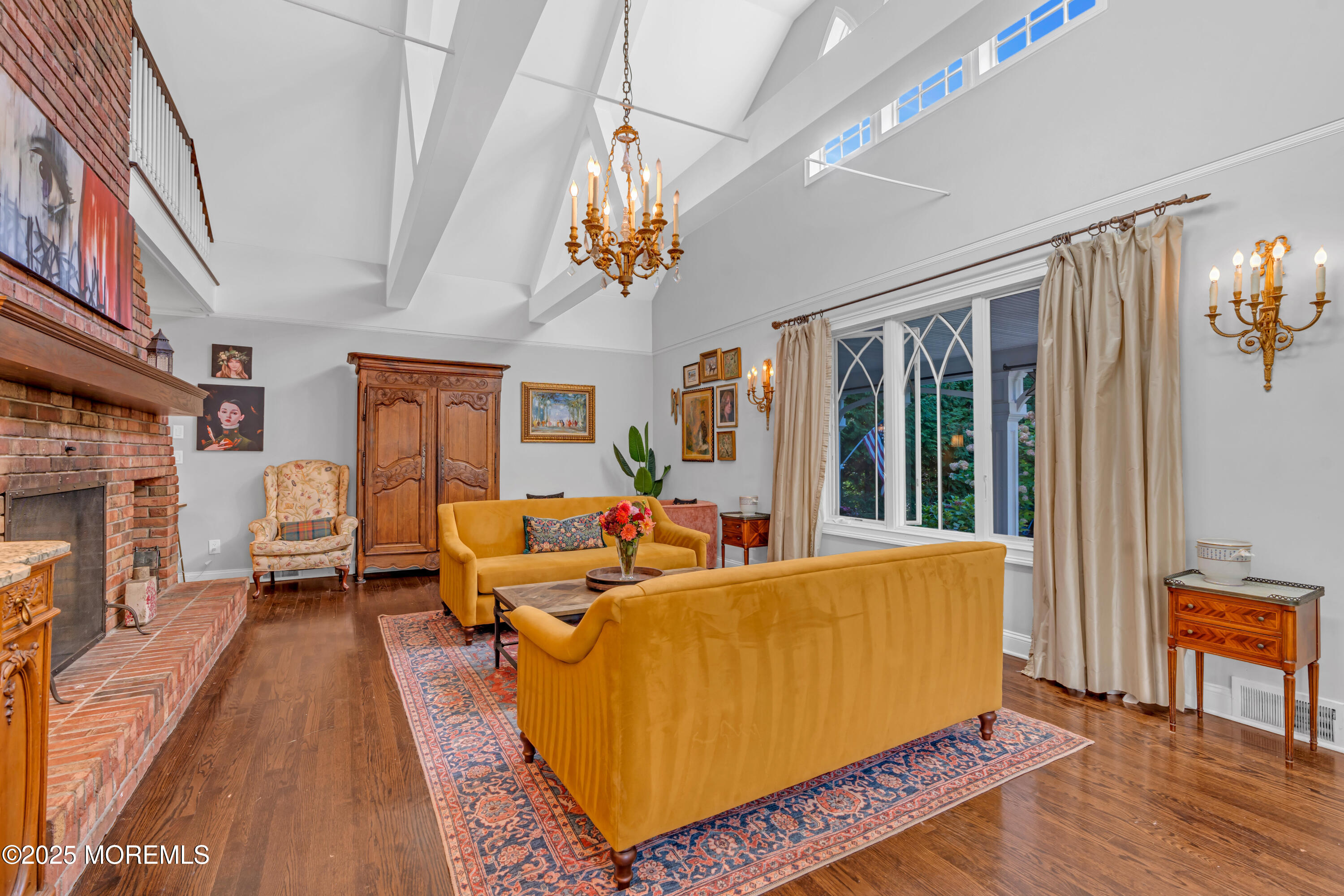 412 Brighton Avenue Spring Lake, NJ 07762 - Photo 6 of 56 a living room with furniture a chandelier and a fireplace