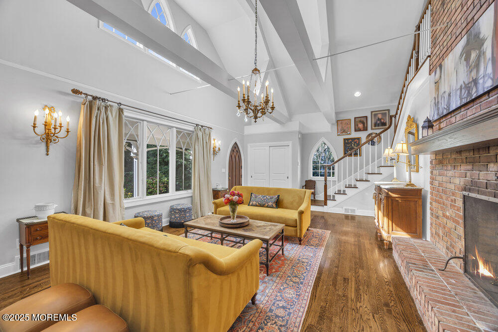412 Brighton Avenue Spring Lake, NJ 07762 - Photo 7 of 56 a living room with furniture a chandelier and a rug