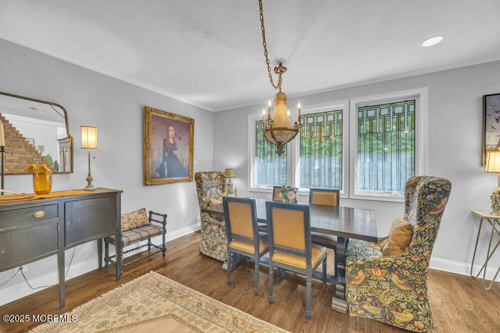 412 Brighton Avenue Spring Lake, NJ 07762 - Photo 10 of 56 a view of a dining room with furniture a chandelier and wooden floor