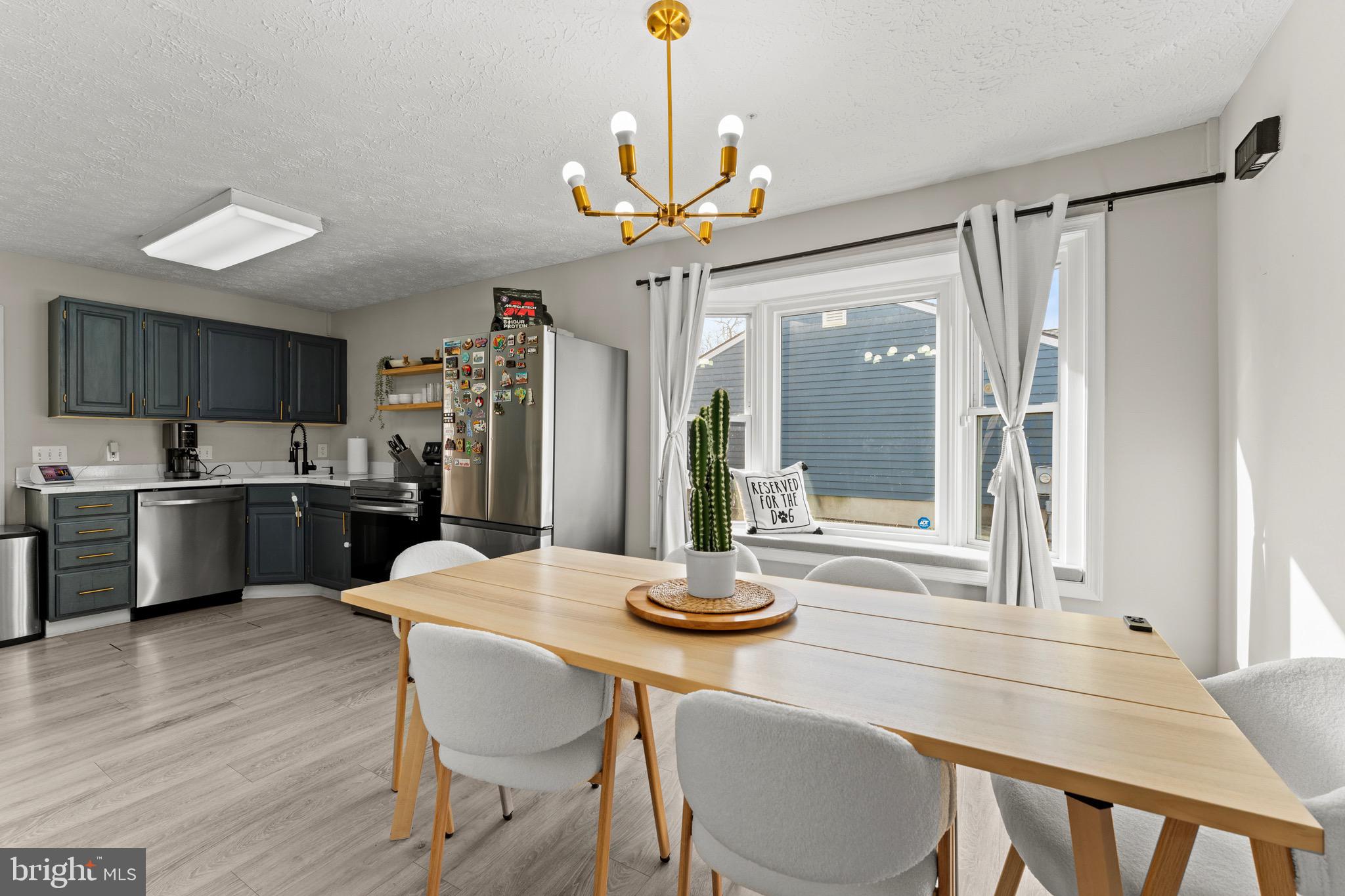 28 Queen Anne Road Glen Burnie, MD 21060 - Photo 11 of 47 a kitchen with granite countertop a table chairs stove and cabinets