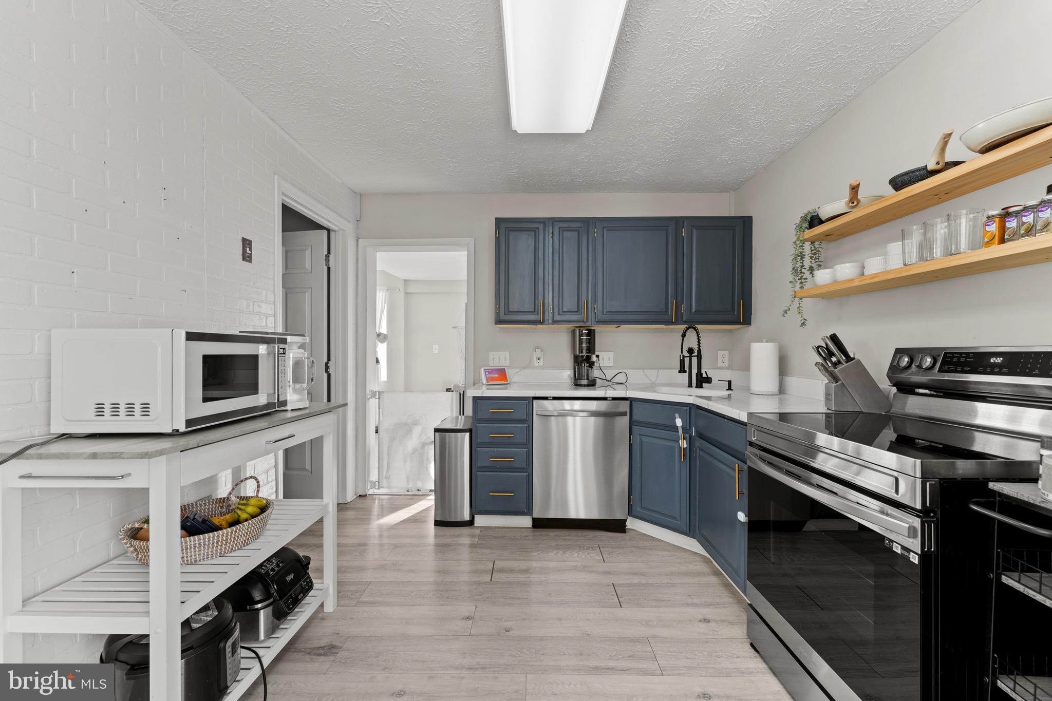 28 Queen Anne Road Glen Burnie, MD 21060 - Photo 16 of 47 a kitchen with a sink and a stove top oven