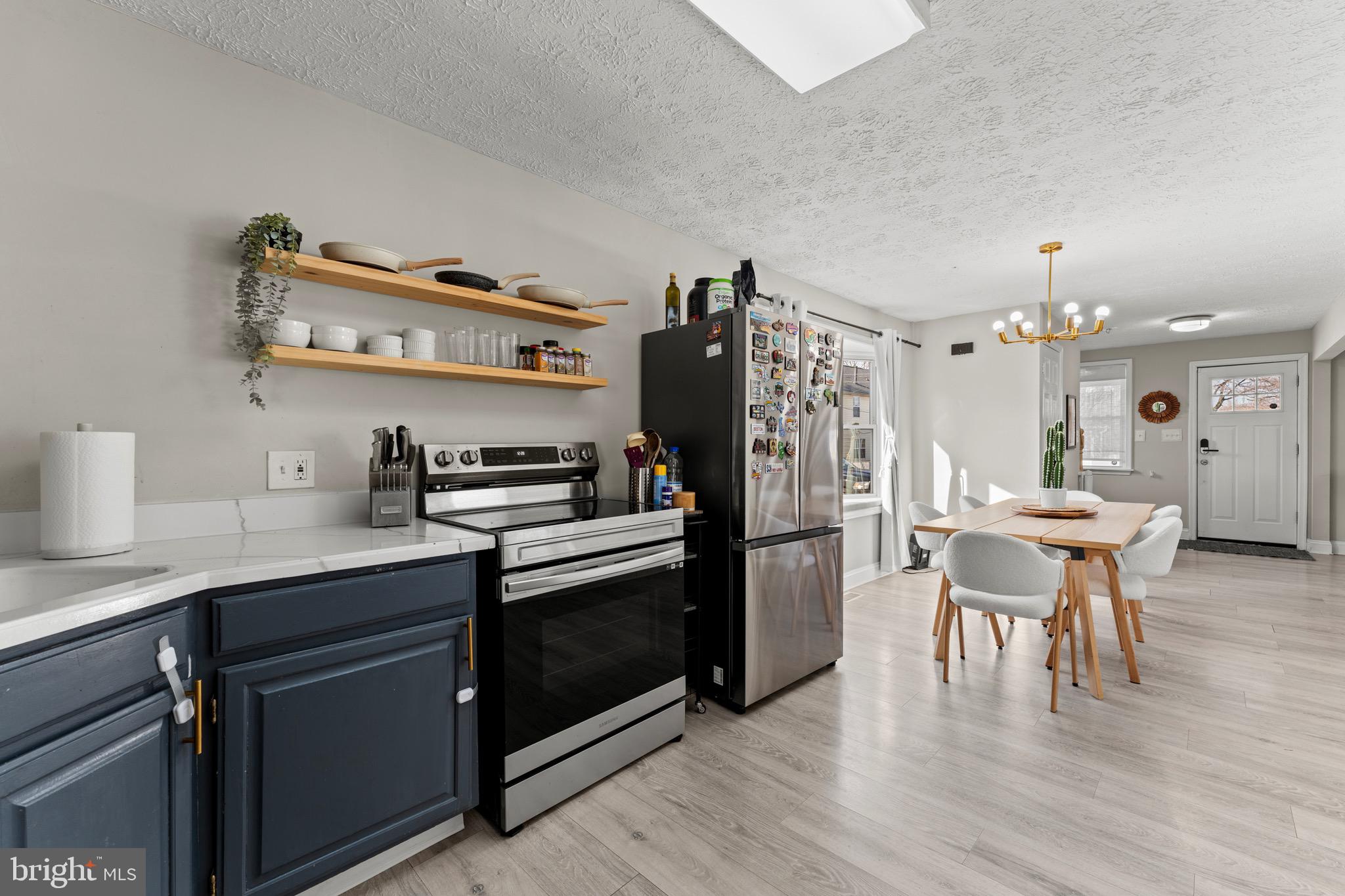28 Queen Anne Road Glen Burnie, MD 21060 - Photo 17 of 47 a kitchen with a refrigerator and a stove top open