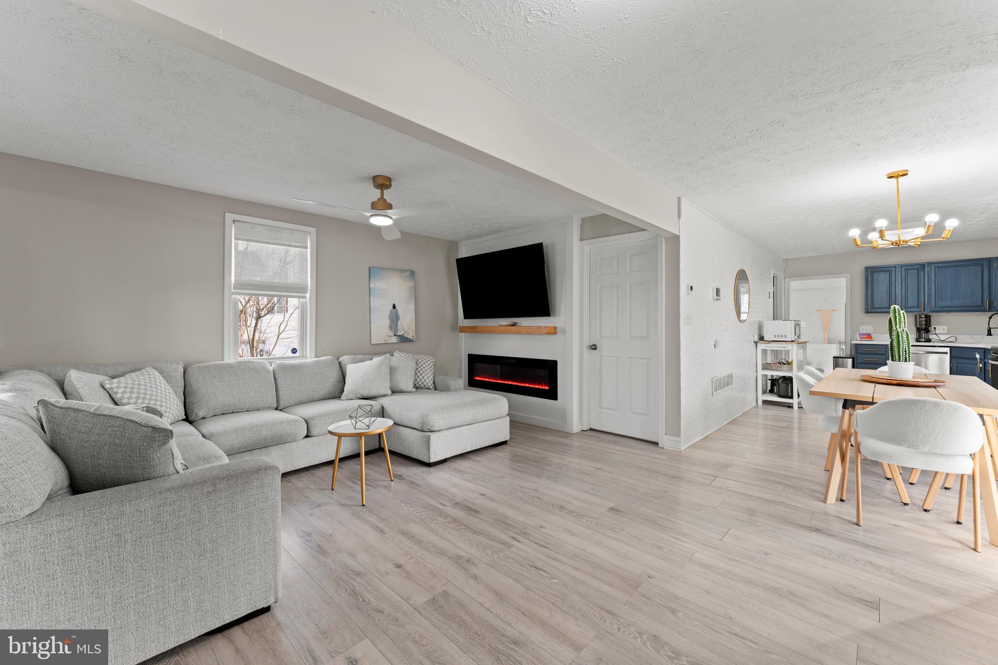 28 Queen Anne Road Glen Burnie, MD 21060 - Photo 2 of 47 a living room with furniture and a flat screen tv