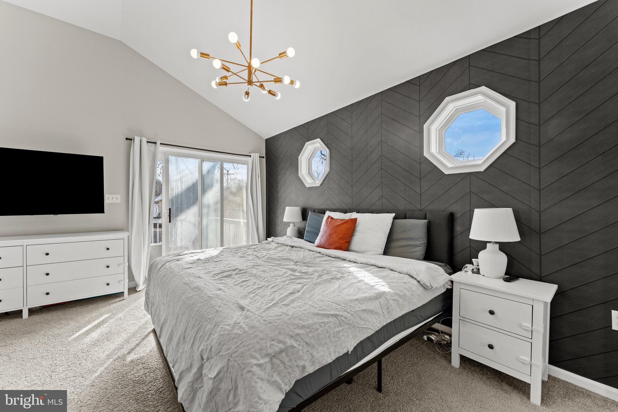 28 Queen Anne Road Glen Burnie, MD 21060 - Photo 33 of 47 a bedroom with a bed and a flat tv screen on dresser