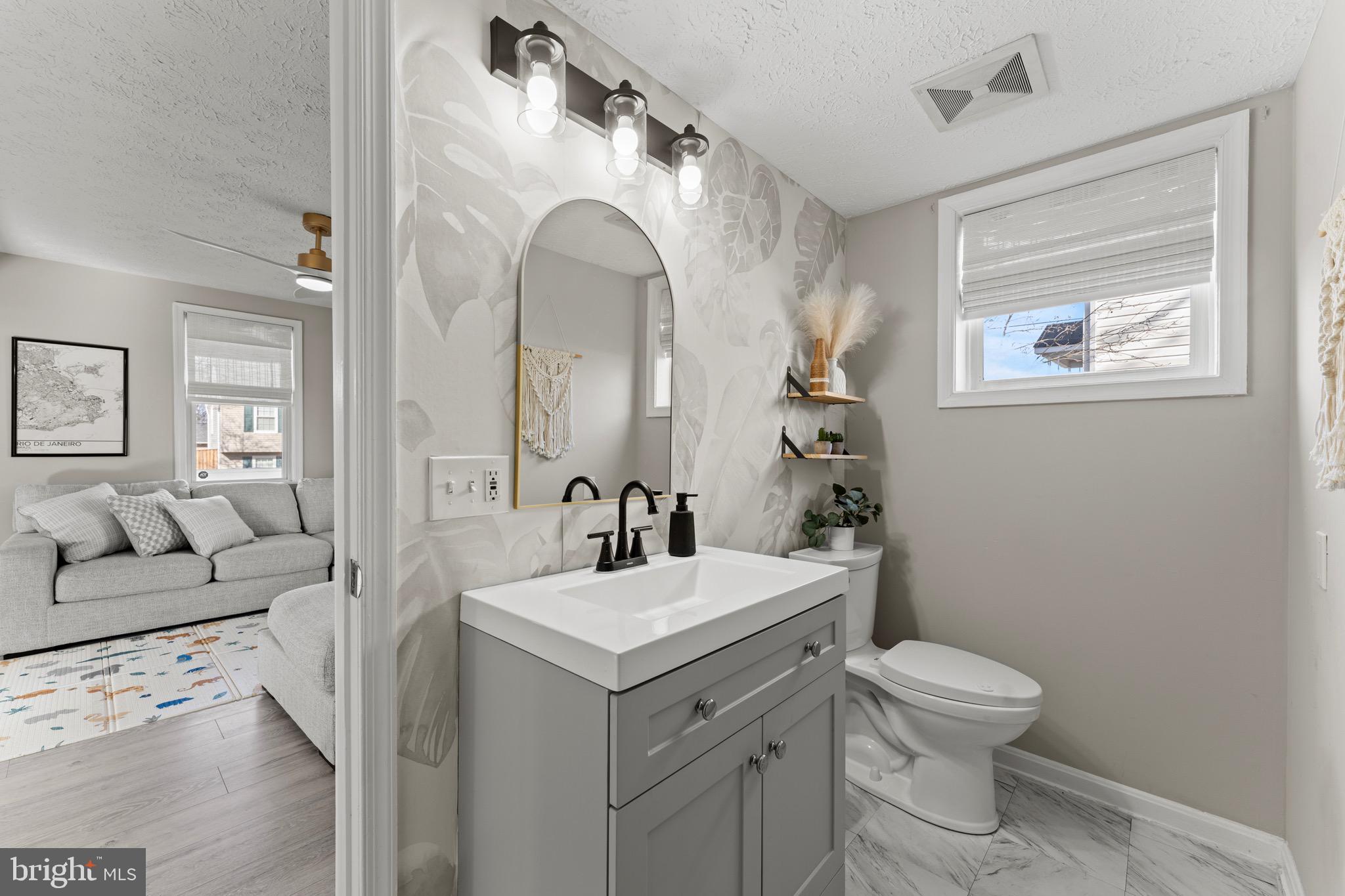 28 Queen Anne Road Glen Burnie, MD 21060 - Photo 8 of 47 a bathroom with a toilet sink and mirror