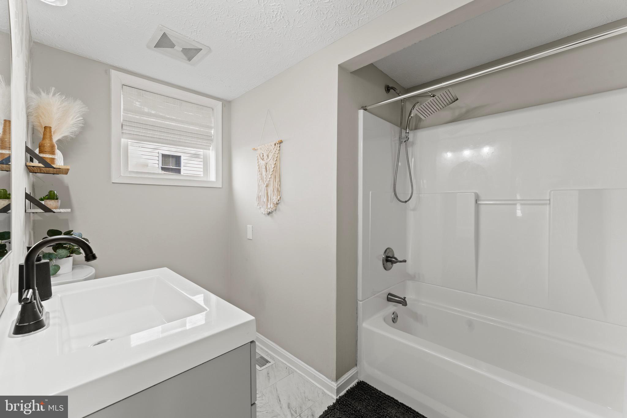 28 Queen Anne Road Glen Burnie, MD 21060 - Photo 9 of 47 a bathroom with a bathtub shower sink vanity and a toilet