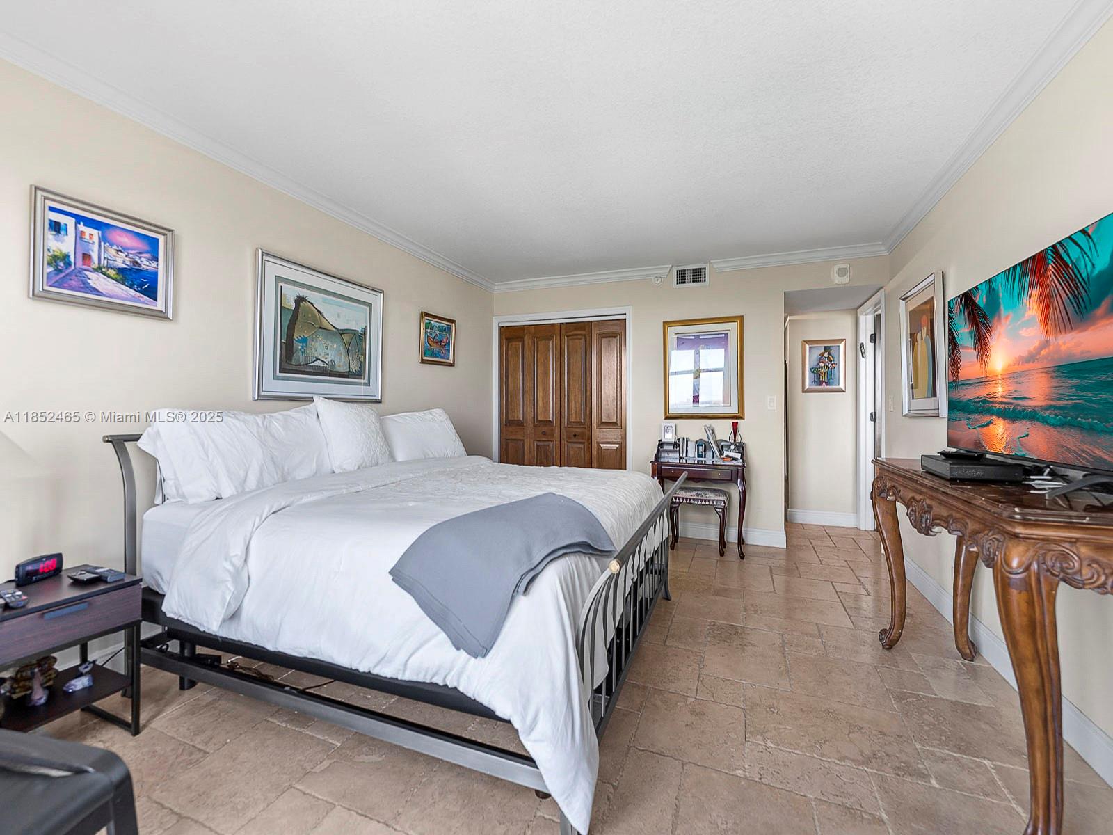 1000 Quayside Terrace, Unit 706 Miami, FL 33138 - Photo 13 of 33 a spacious bedroom with a bed and a flat screen tv