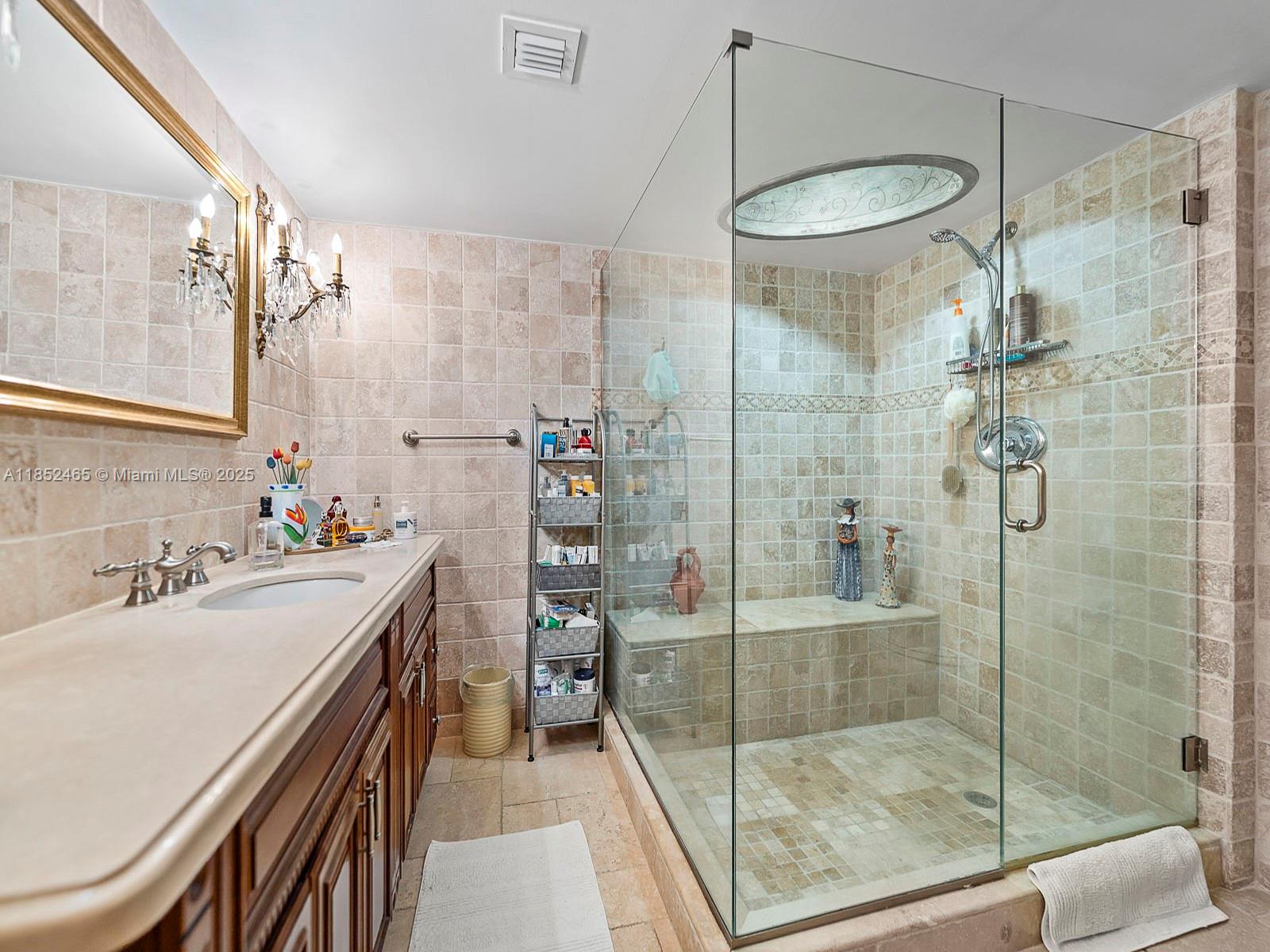 1000 Quayside Terrace, Unit 706 Miami, FL 33138 - Photo 14 of 33 a bathroom with a shower sink and mirror