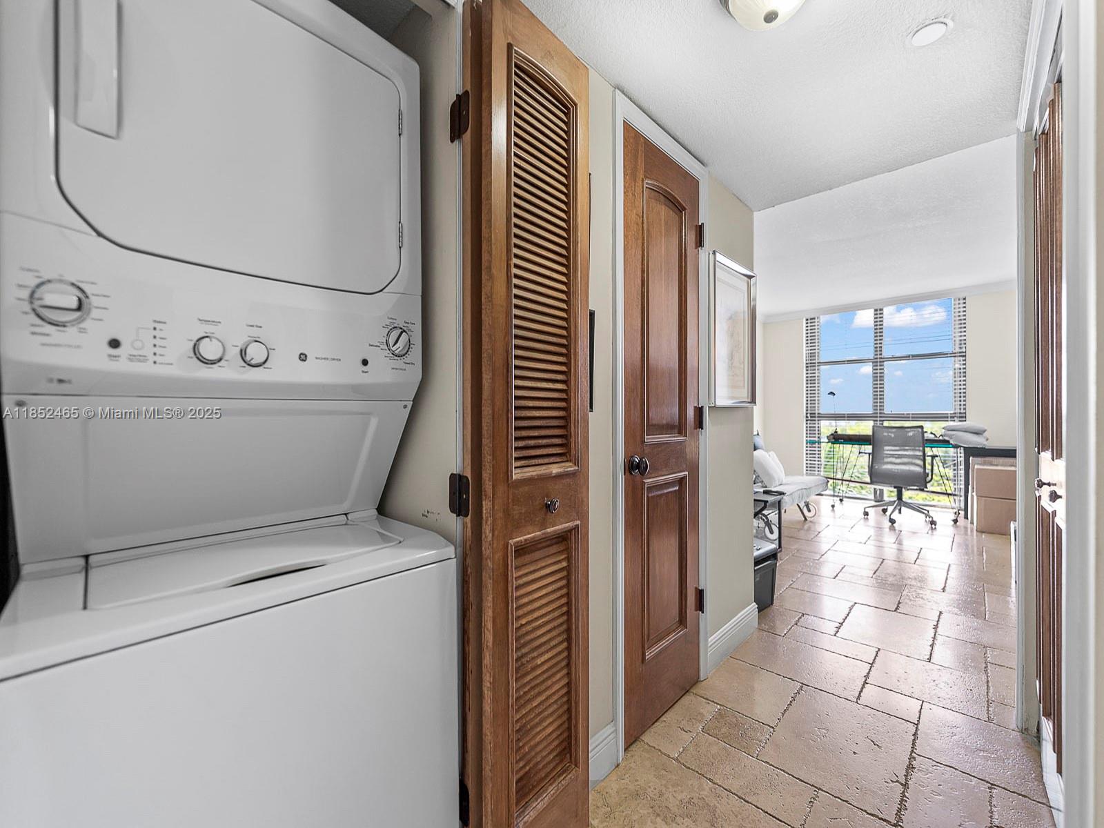 1000 Quayside Terrace, Unit 706 Miami, FL 33138 - Photo 16 of 33 a view of washer and dryer with kitchen in the background