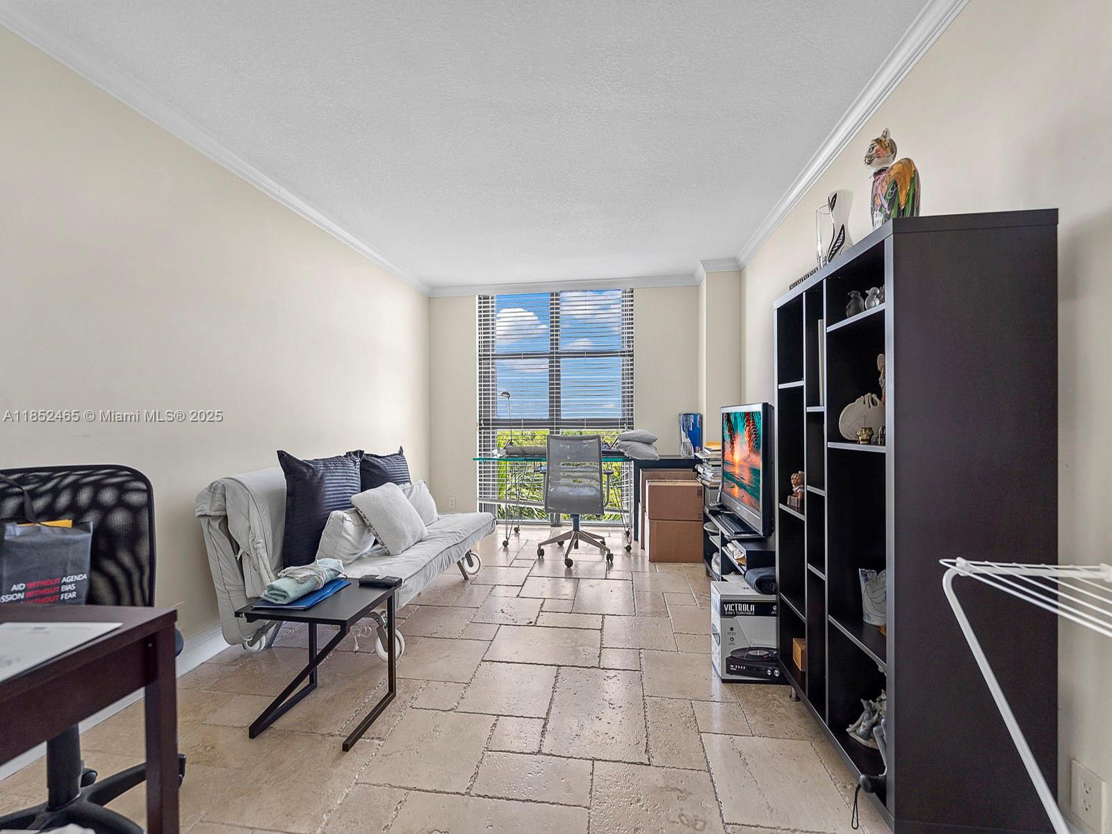 1000 Quayside Terrace, Unit 706 Miami, FL 33138 - Photo 17 of 33 a living room with furniture a window and a flat screen tv