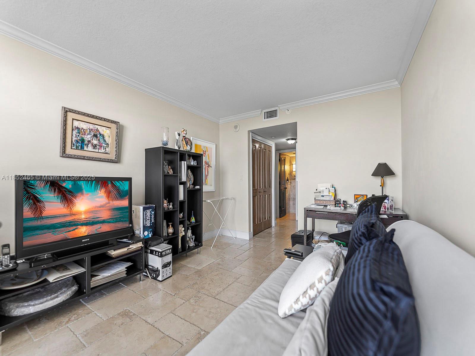 1000 Quayside Terrace, Unit 706 Miami, FL 33138 - Photo 18 of 33 a room with furniture a flat screen tv and gym equipment