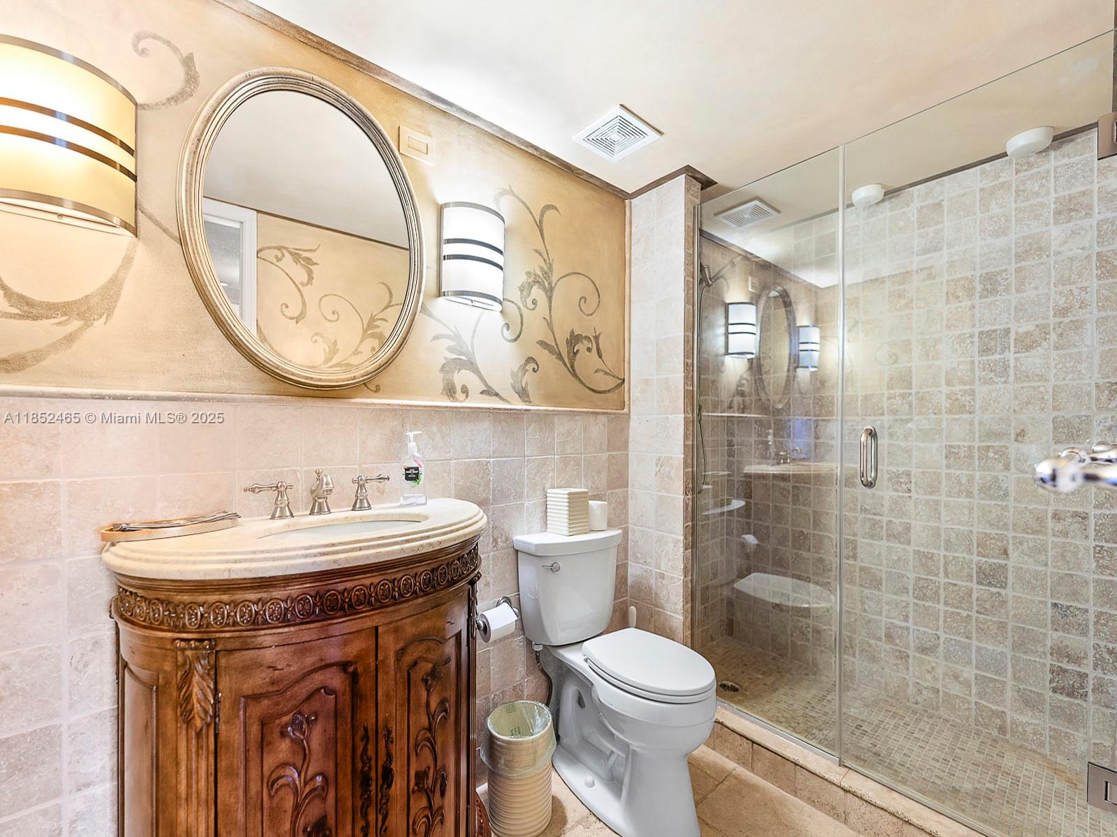 1000 Quayside Terrace, Unit 706 Miami, FL 33138 - Photo 19 of 33 a bathroom with a sink a toilet and a mirror