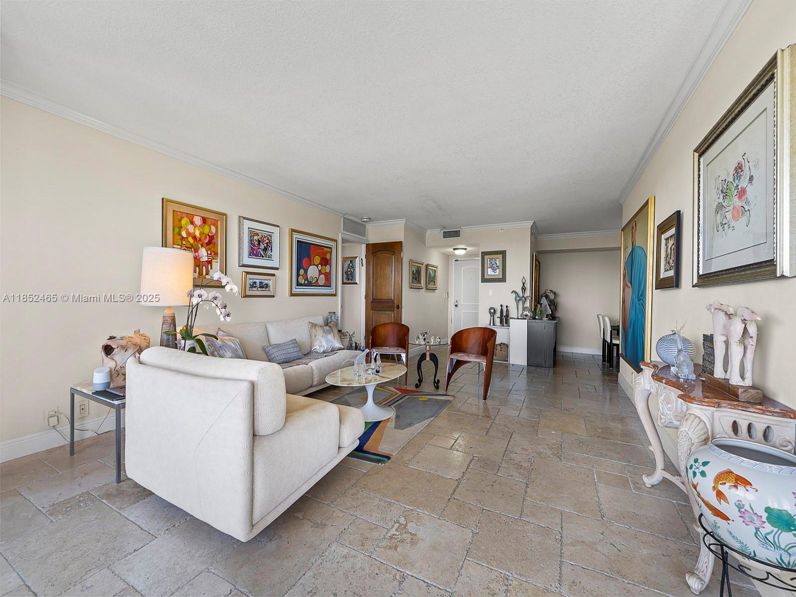 1000 Quayside Terrace, Unit 706 Miami, FL 33138 - Photo 5 of 33 a living room with furniture and a bookshelf