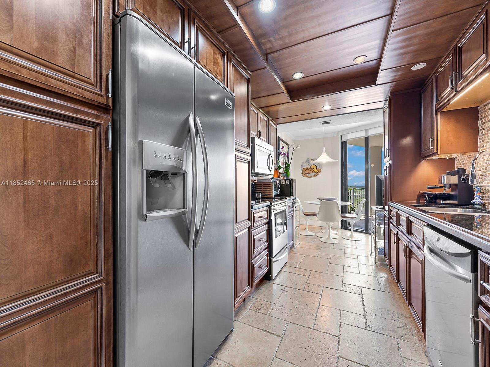 1000 Quayside Terrace, Unit 706 Miami, FL 33138 - Photo 8 of 33 a kitchen with stainless steel appliances granite countertop a refrigerator and a sink