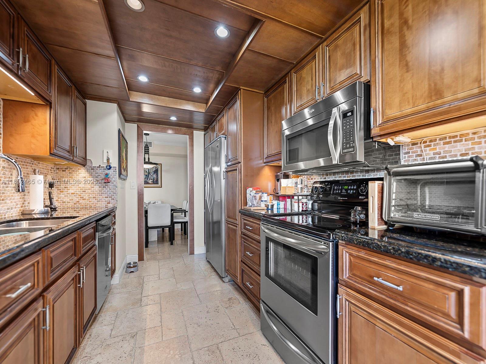 1000 Quayside Terrace, Unit 706 Miami, FL 33138 - Photo 10 of 33 a kitchen with stainless steel appliances granite countertop a stove and a refrigerator