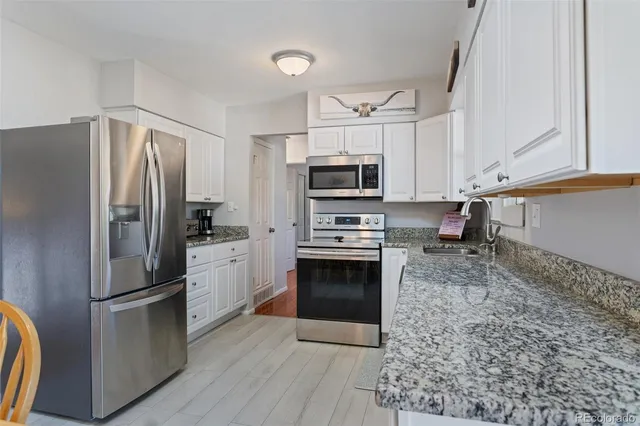 a kitchen with stainless steel appliances a refrigerator sink and microwave