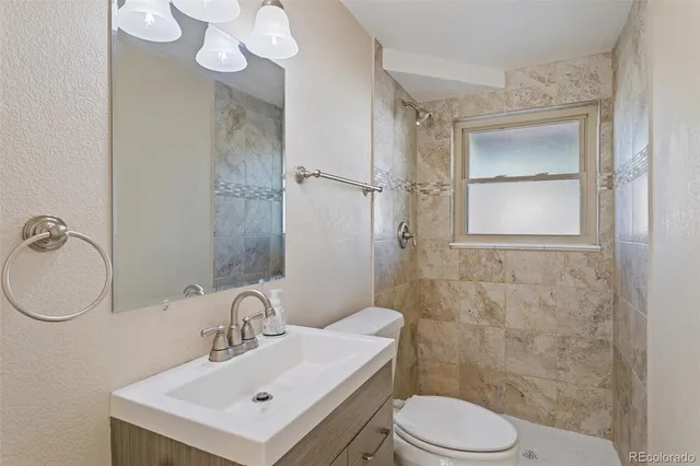 a living room with furniture a flat screen tv and a window