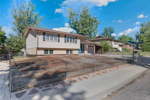 a house that has a tree in front of it