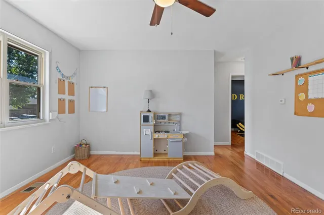 a room with a bed and a wooden floor