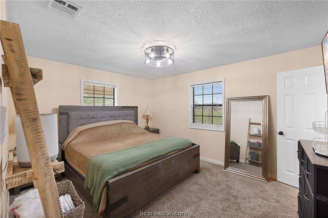 3540 Fisher Ranch Road Bryan, TX 77808 - Photo 12 of 36 a bedroom with a bed and window