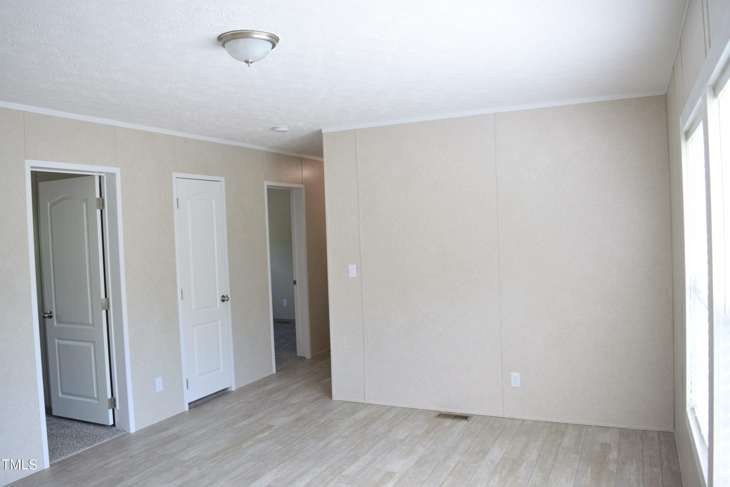 4370 Needham Road Bailey, NC 27807 - Photo 17 of 41 an empty room with wooden floor and windows