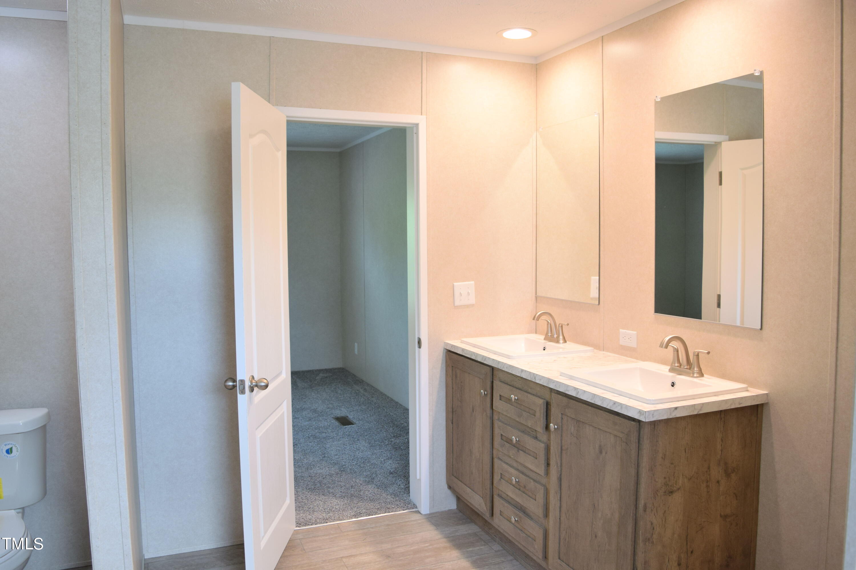 4370 Needham Road Bailey, NC 27807 - Photo 19 of 41 a bathroom with a double vanity sink mirror and