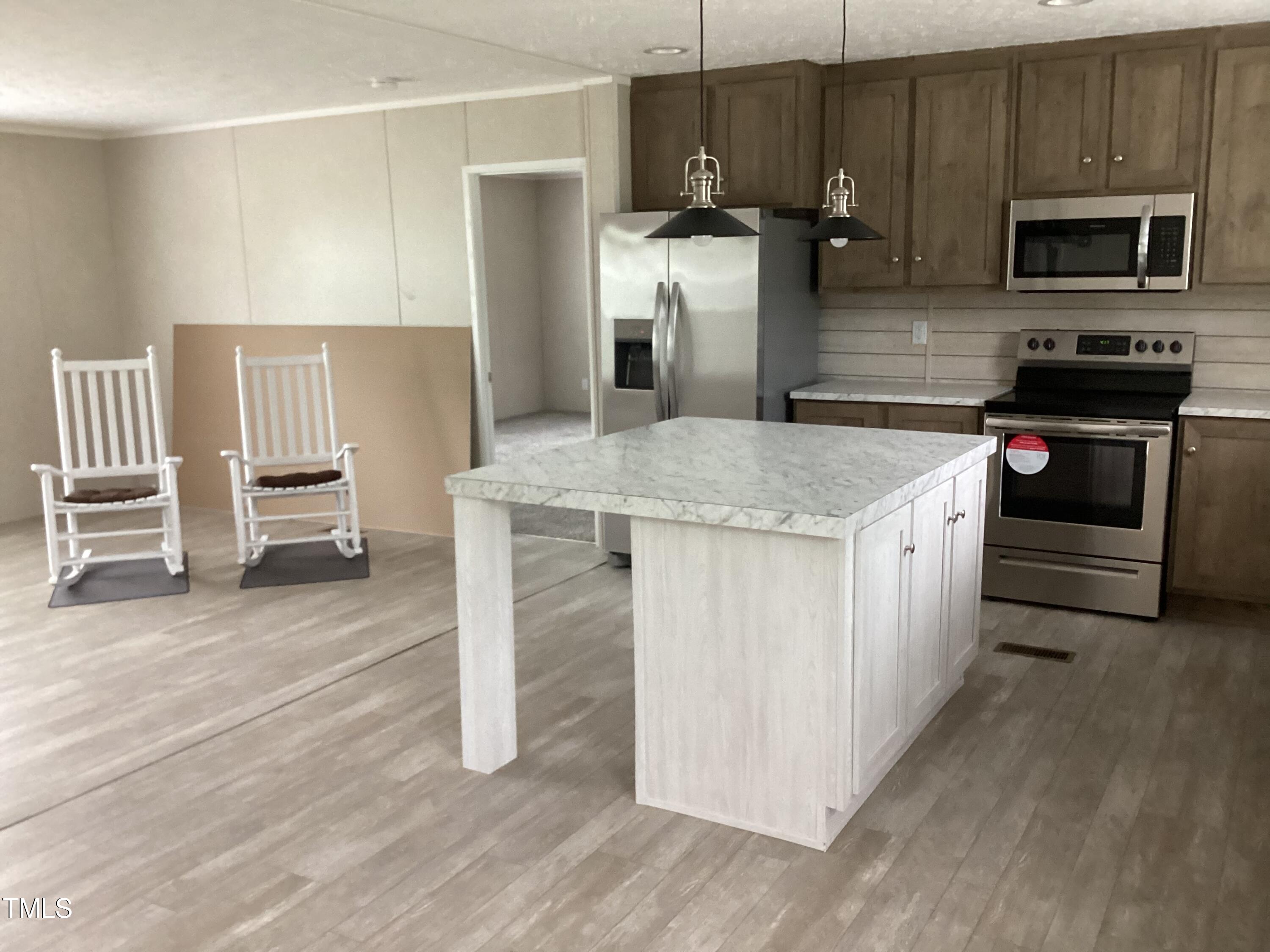 4370 Needham Road Bailey, NC 27807 - Photo 3 of 41 a kitchen with stainless steel appliances kitchen island granite countertop a stove and a refrigerator