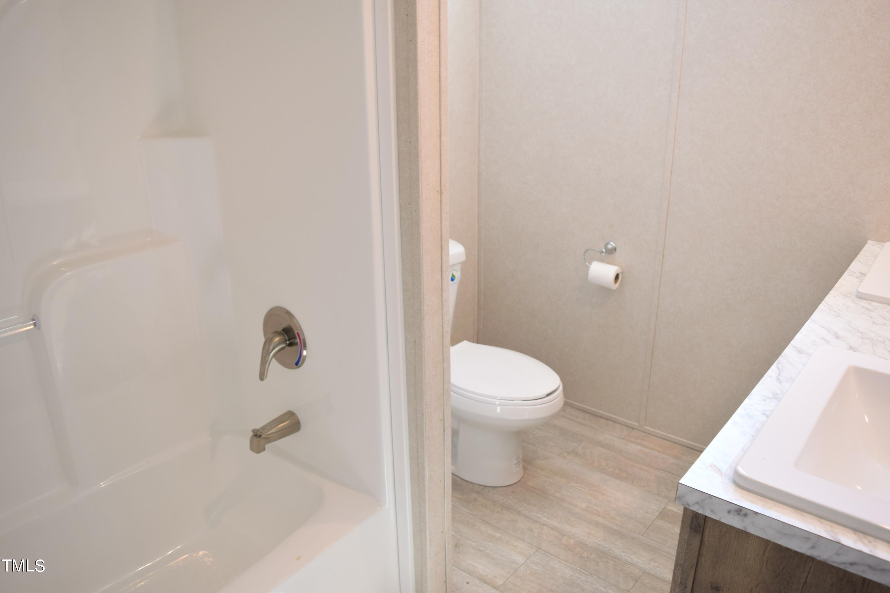 4370 Needham Road Bailey, NC 27807 - Photo 32 of 41 a white toilet sitting next to a bathroom sink