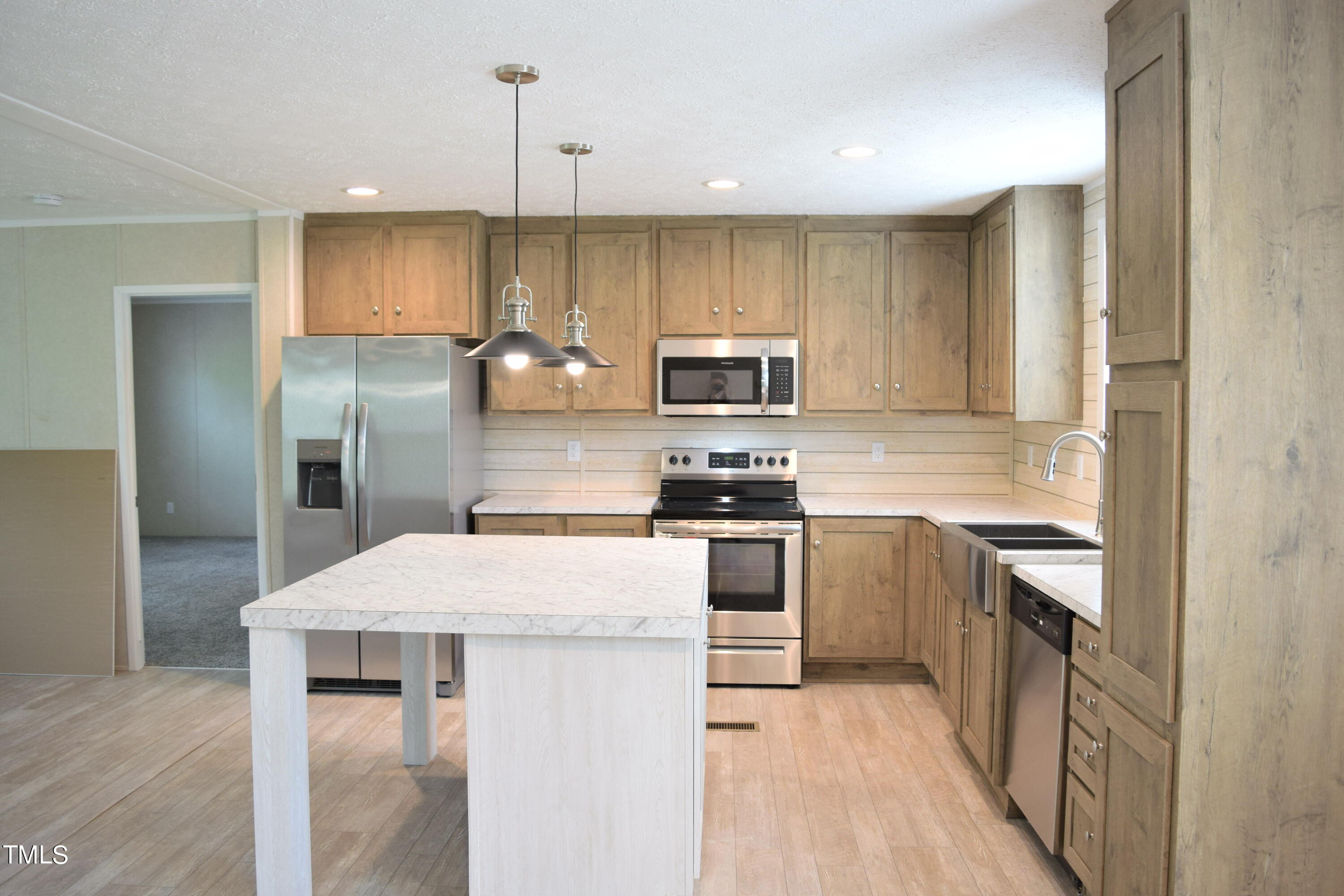 4370 Needham Road Bailey, NC 27807 - Photo 6 of 41 a kitchen with kitchen island a counter top space stainless steel appliances and cabinets