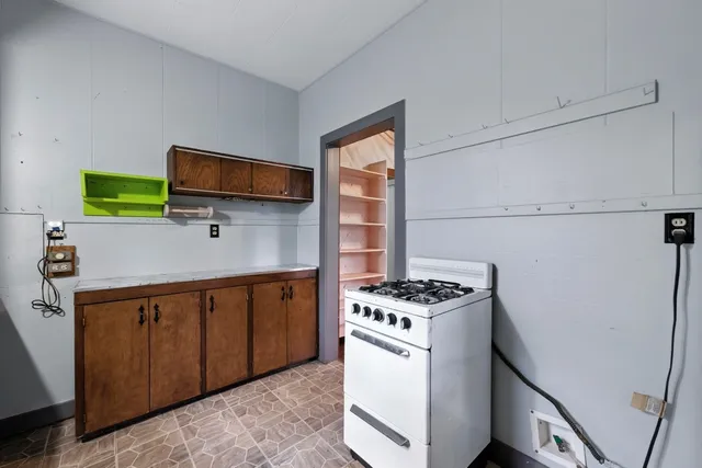 a kitchen with stainless steel appliances a stove microwave and refrigerator