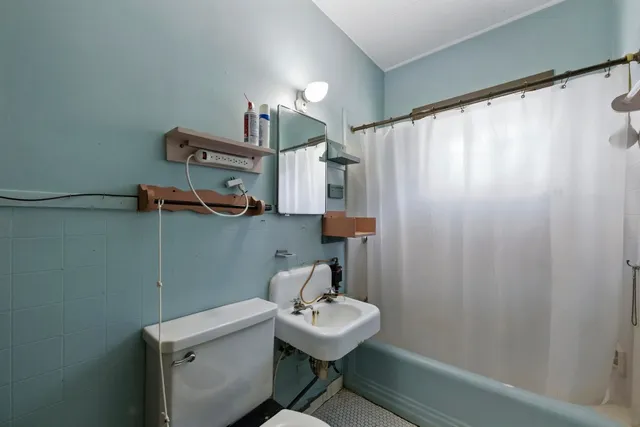 a bathroom with a sink a mirror and a shower