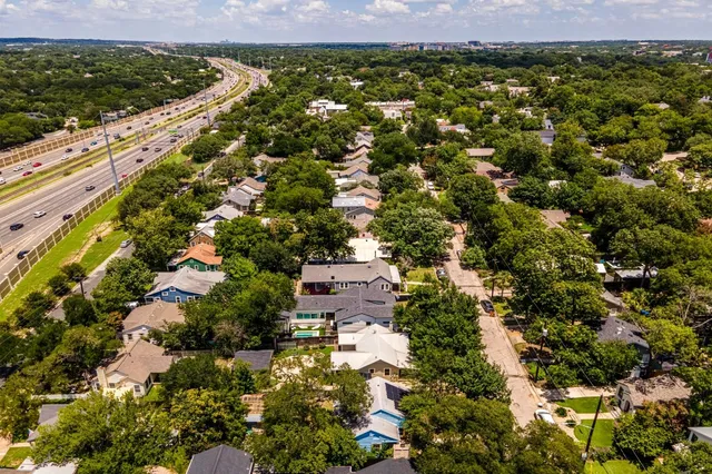 an aerial view of residential houses with outdoor space