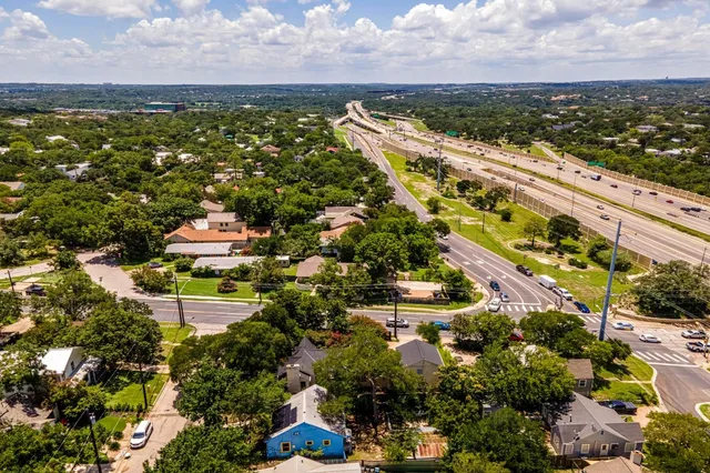 an aerial view of beach and residential houses with outdoor space