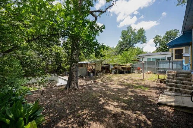 a view of a house with a yard and sitting area