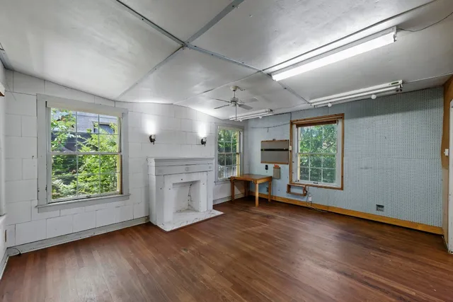 wooden floor in an empty room with a window
