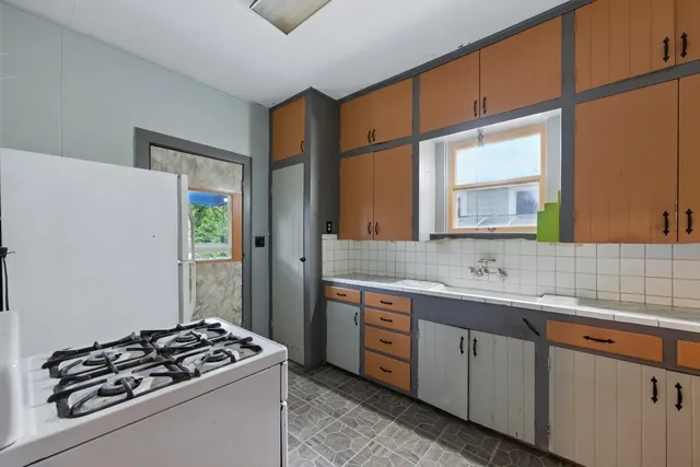 a kitchen with a sink stove and cabinets
