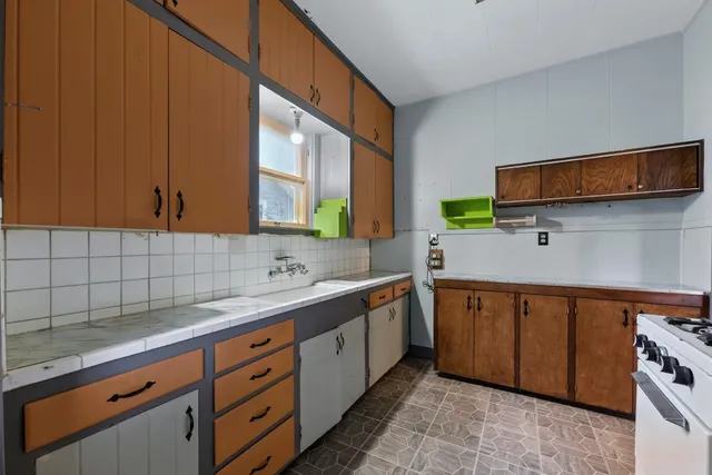 a kitchen with stainless steel appliances granite countertop a sink stove and microwave