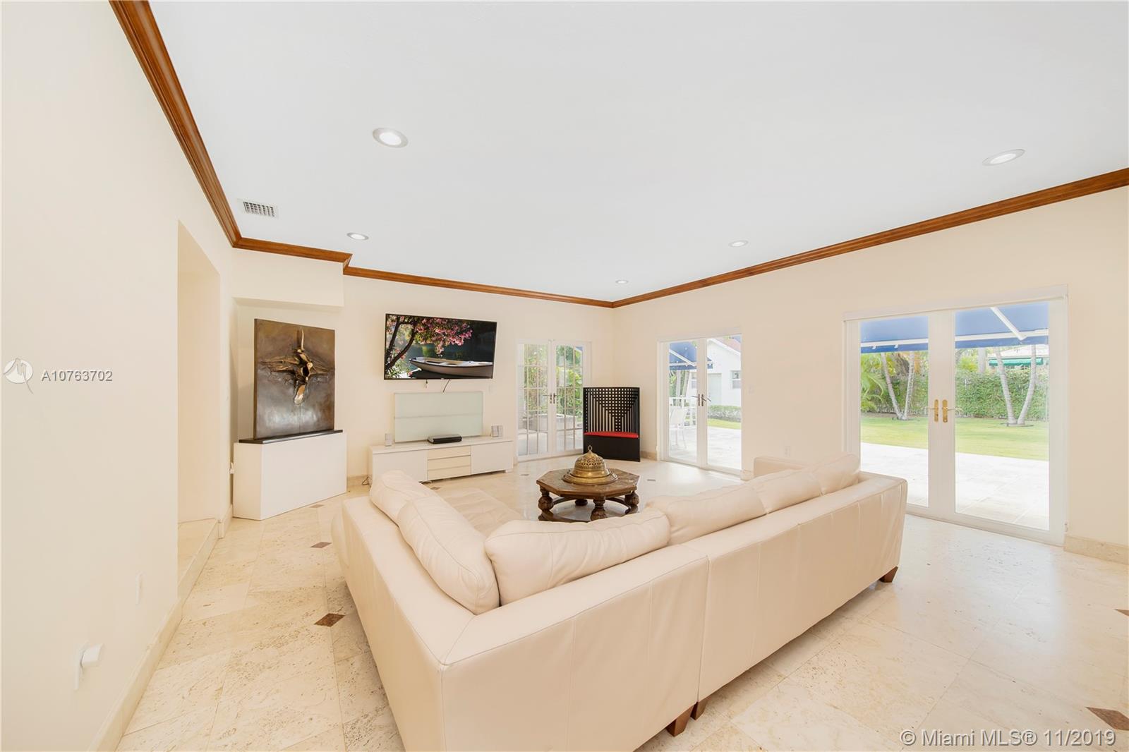 244 Southwest 28th Road Miami, FL 33129 - Photo 11 of 43 a living room with furniture and a flat screen tv